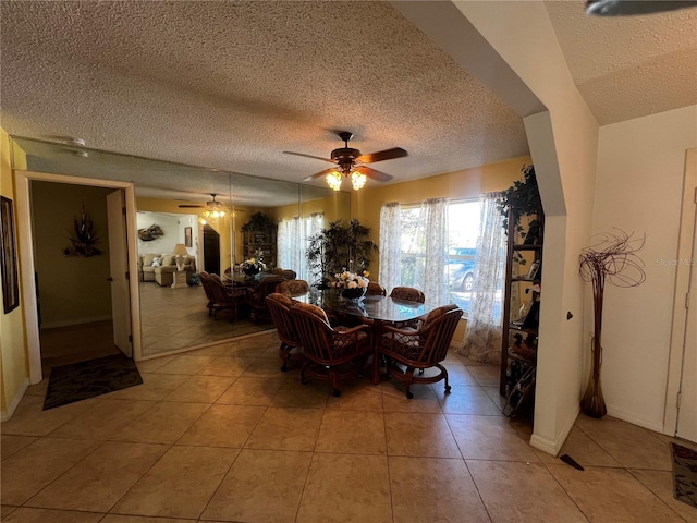 dining room with ceiling fan, light tile patterned floors, and a textured ceiling