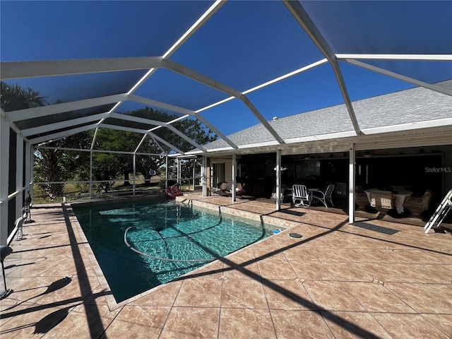 view of pool with a lanai and a patio