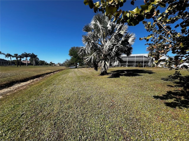 view of yard with glass enclosure