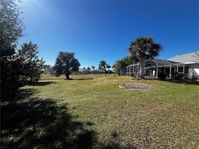 view of yard with a lanai