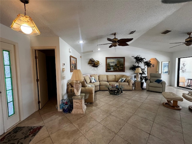 living room featuring a textured ceiling, vaulted ceiling, and ceiling fan