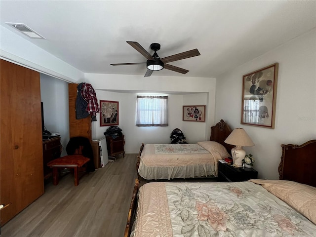 bedroom with light hardwood / wood-style flooring and ceiling fan