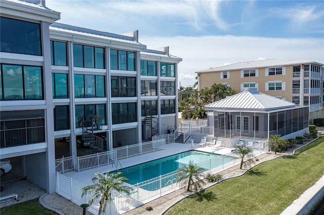 view of swimming pool with a patio area and a sunroom