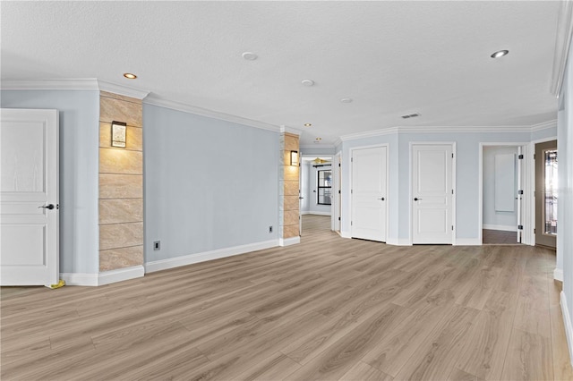 unfurnished living room with a textured ceiling, light wood-type flooring, and crown molding