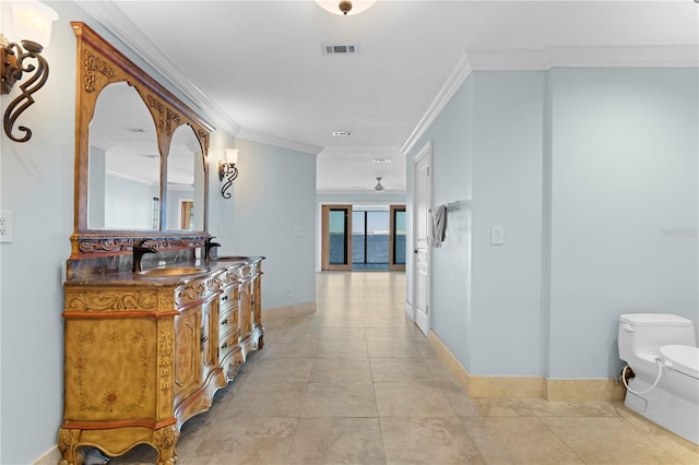 hall featuring crown molding, sink, and light tile patterned floors