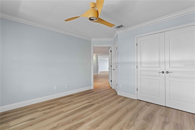 1600 W Marion Ave Unit 234, Punta Gorda, FL 33950 - unfurnished bedroom featuring ornamental molding, light wood-style flooring, a closet, and a ceiling fan