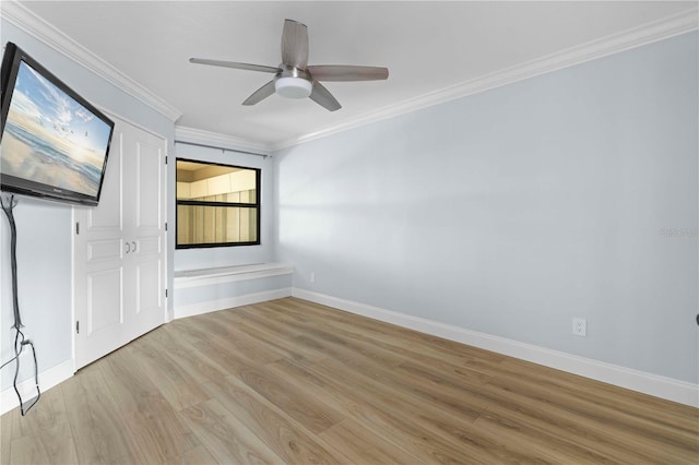 empty room featuring light hardwood / wood-style flooring, ceiling fan, and ornamental molding