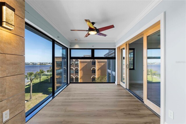 1600 W Marion Ave Unit 234, Punta Gorda, FL 33950 - unfurnished sunroom with a water view, ornamental molding, and wood finished floors