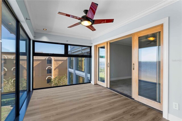 1600 W Marion Ave Unit 234, Punta Gorda, FL 33950 - unfurnished sunroom featuring healthy amount of natural light, wood finished floors, and crown molding