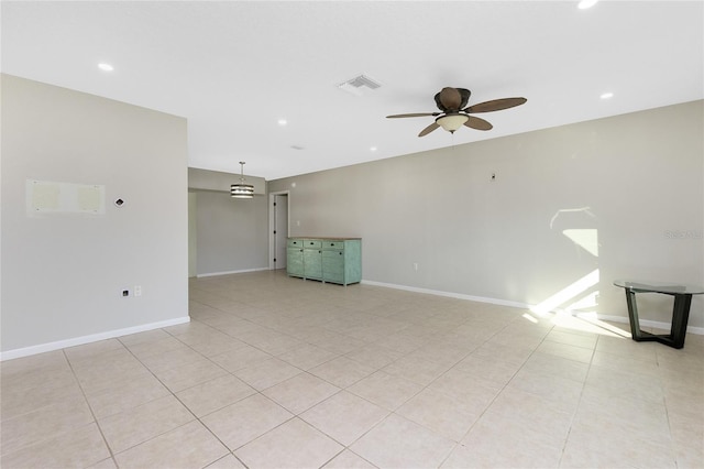 unfurnished living room featuring light tile patterned flooring and ceiling fan