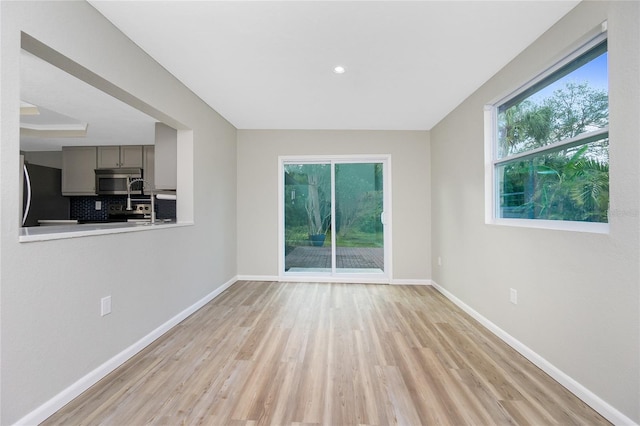 spare room with light hardwood / wood-style flooring