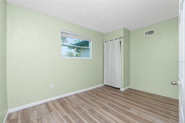 unfurnished bedroom with light wood-type flooring