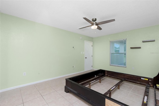 unfurnished bedroom featuring ceiling fan and light tile patterned floors