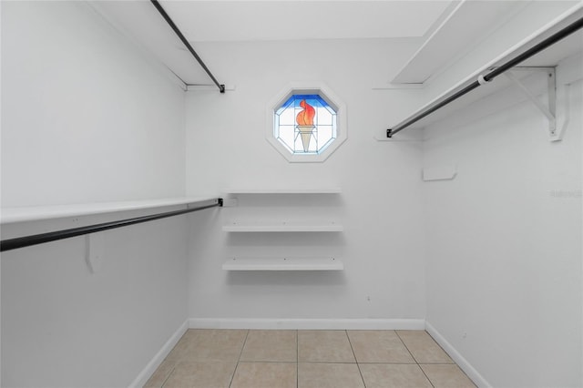 spacious closet featuring light tile patterned flooring