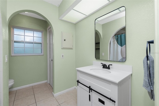 bathroom with vanity, toilet, and tile patterned flooring