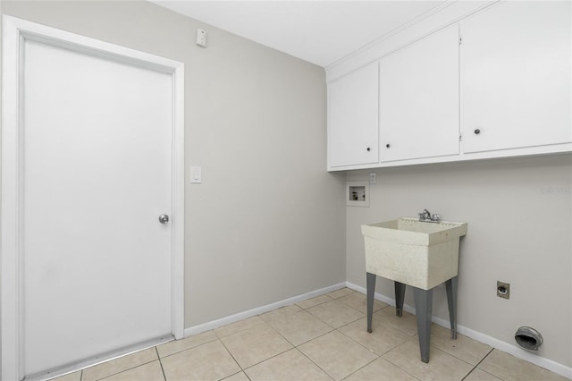 laundry room with cabinets, hookup for an electric dryer, and light tile patterned floors