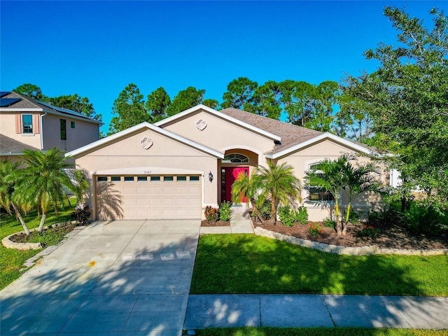 view of front of house featuring a front yard and a garage