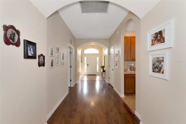 hallway with hardwood / wood-style flooring