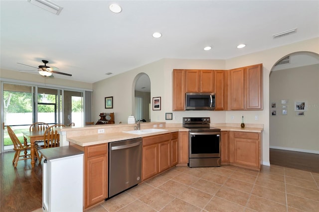 kitchen featuring ceiling fan, sink, light tile patterned floors, and appliances with stainless steel finishes