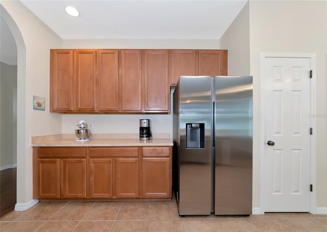 kitchen with stainless steel fridge and light tile patterned floors