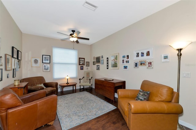 living room with dark hardwood / wood-style flooring and ceiling fan