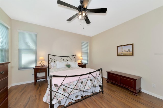 bedroom with ceiling fan and dark wood-type flooring