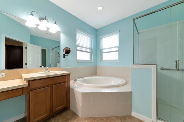 bathroom with vanity, tile patterned flooring, and plus walk in shower