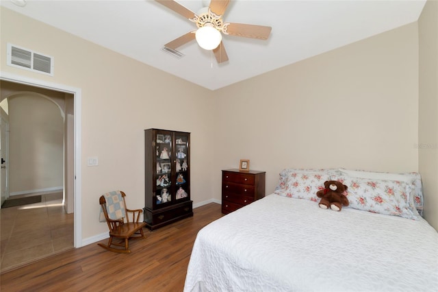 bedroom featuring ceiling fan and dark wood-type flooring