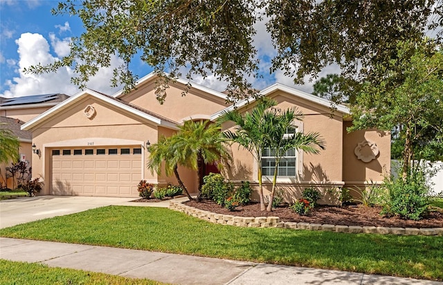 view of front of house with a garage and a front lawn