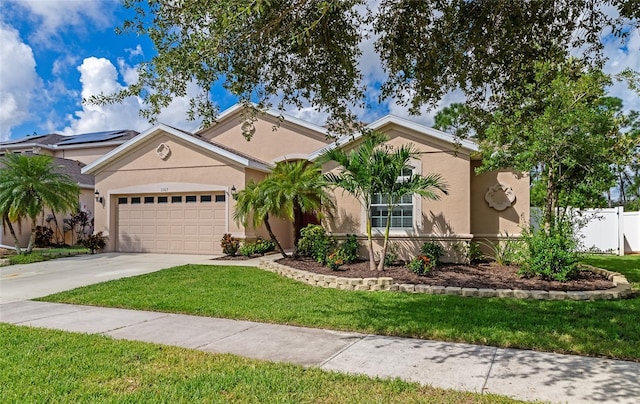 view of front of home featuring a garage and a front lawn