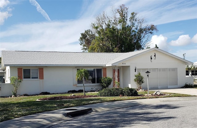 ranch-style home with a garage and a front yard