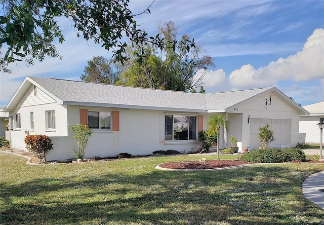 ranch-style home with a front yard and a garage