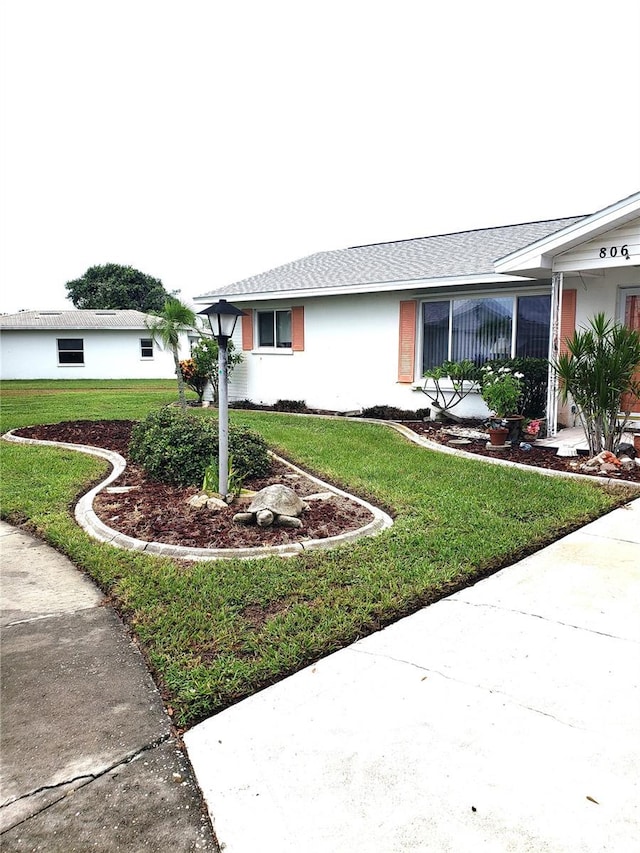 ranch-style home featuring a front yard