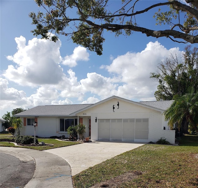 single story home with a front yard and a garage