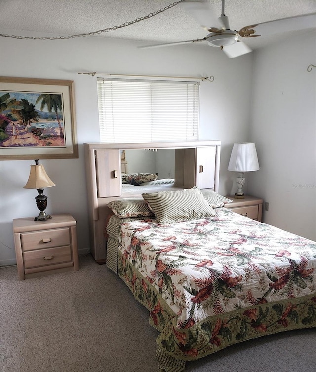 carpeted bedroom featuring ceiling fan and a textured ceiling