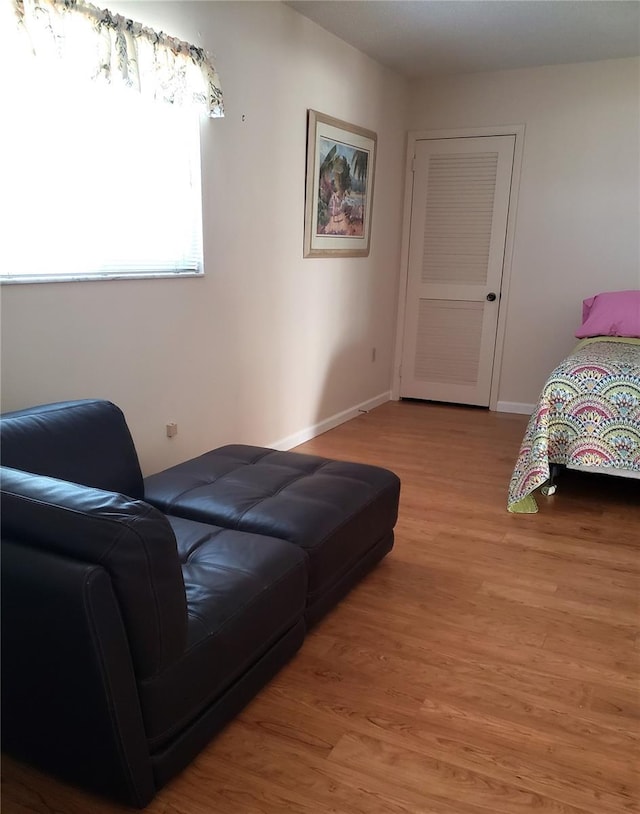bedroom featuring light wood-style flooring and baseboards