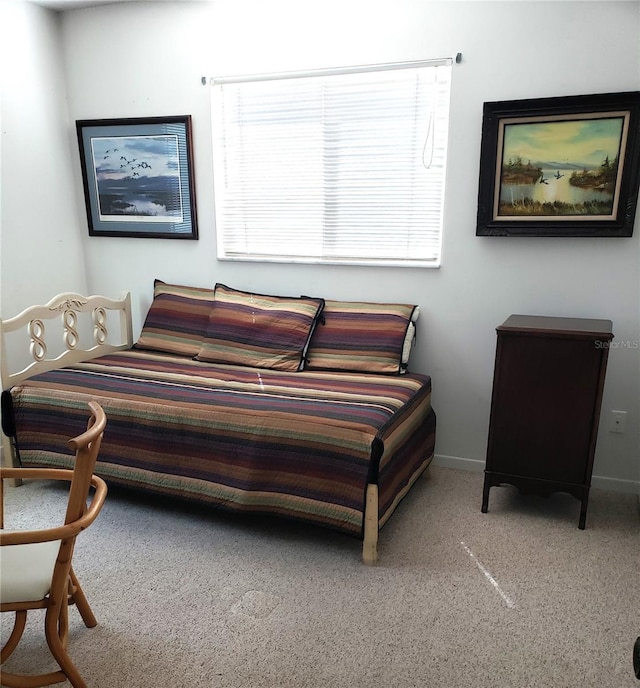 carpeted bedroom featuring baseboards