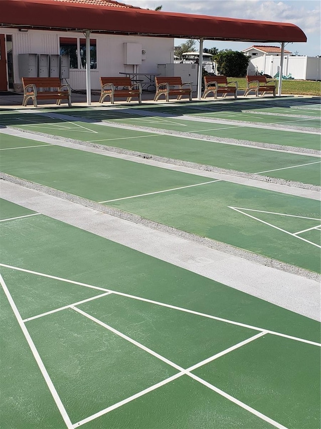 surrounding community featuring shuffleboard and fence