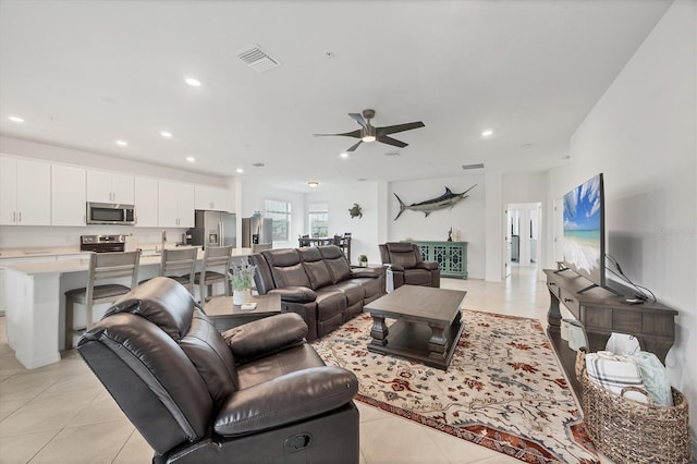 tiled living room with ceiling fan