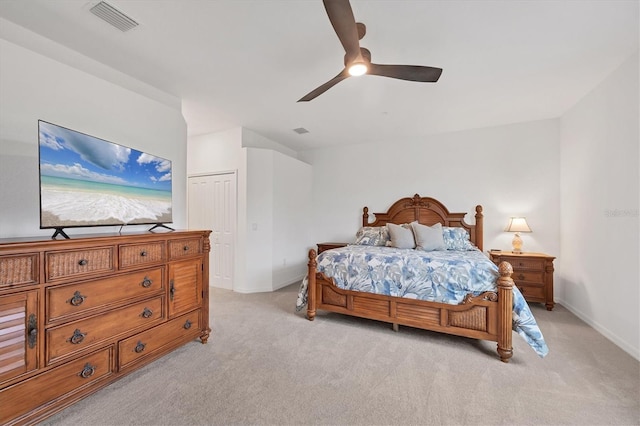 bedroom with ceiling fan, a closet, and light colored carpet