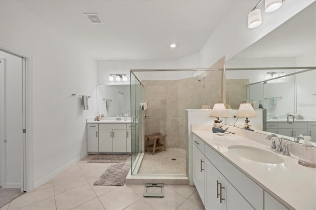 bathroom with tile patterned flooring, vanity, and an enclosed shower