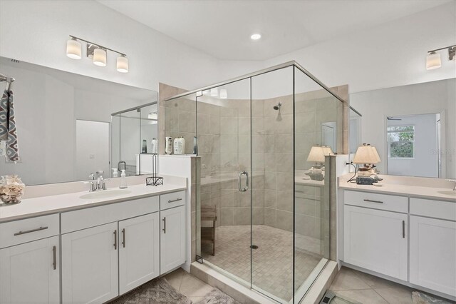 bathroom with vanity, tile patterned floors, and a shower with door