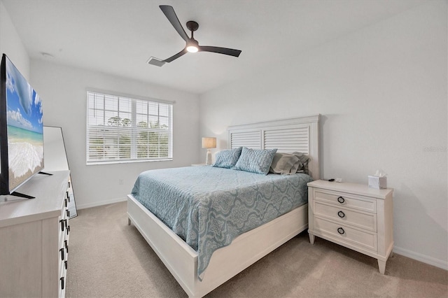 bedroom with ceiling fan and light carpet