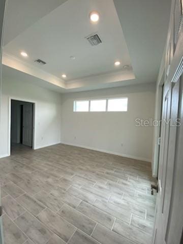 spare room featuring a raised ceiling