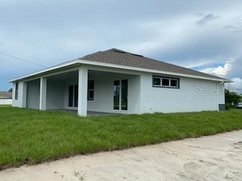 rear view of house with a lawn