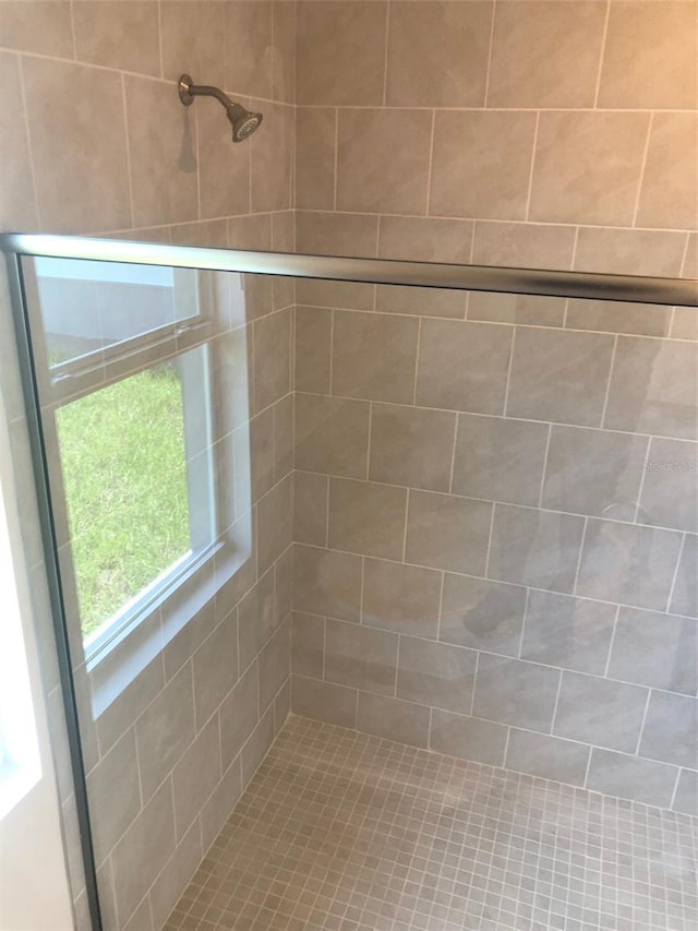 bathroom with tiled shower