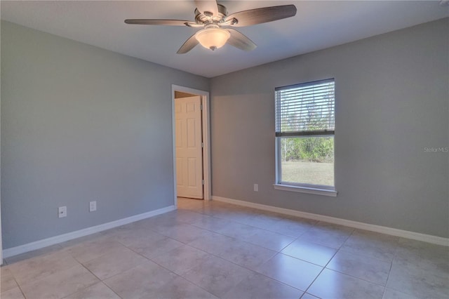 empty room featuring ceiling fan and light tile patterned floors