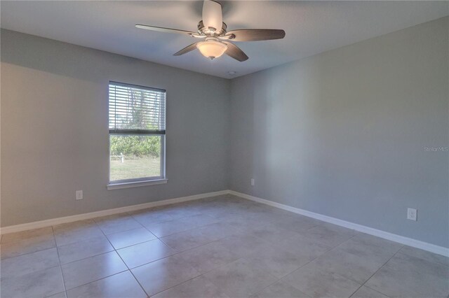 empty room with light tile patterned flooring and ceiling fan