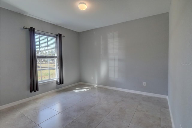 spare room featuring light tile patterned floors