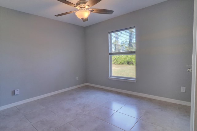 tiled spare room with ceiling fan